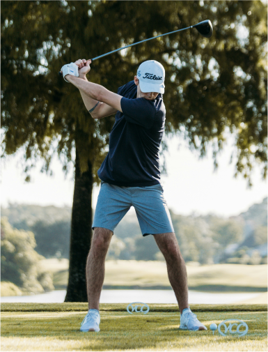 Mens golfer swinging with a driver