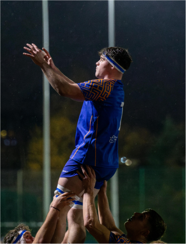 Mens rugby player lineout lifted in the air