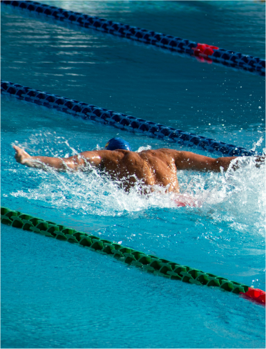 Butterfly stroke swimmer in pool