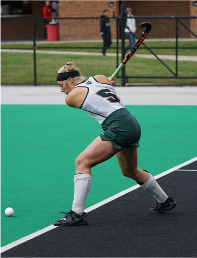 Woman playing field hockey